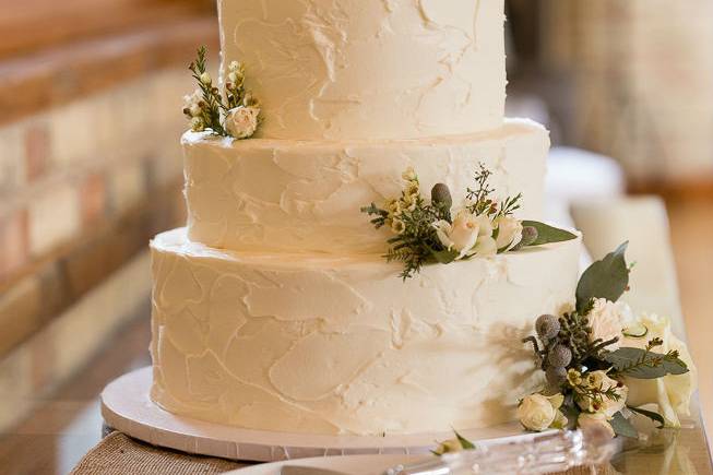 4 tier wedding cake with stucco texture and fresh floral