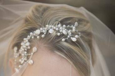 Portrait of a bride looking seductively under her veil.