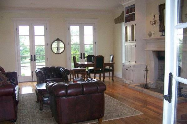 4 sets of french doors connect guests in the formal drawing room from front veranda to covered back porch which is then connected to a 90 foot wide back patio.