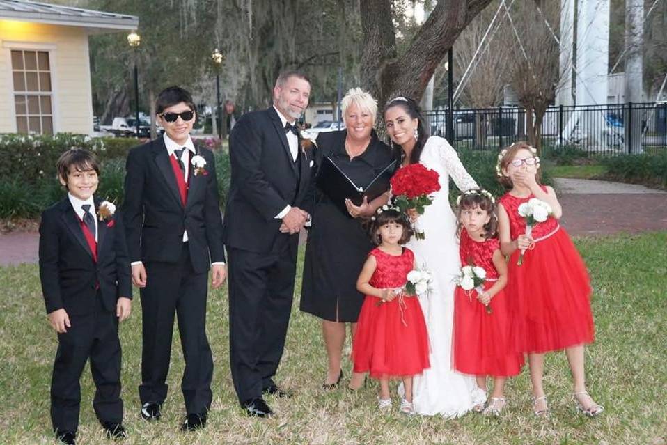 Newlyweds and their family with the officiant