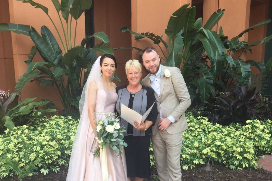 Groom and bride with the officiant