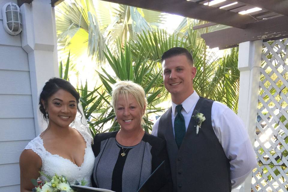 Bride and groom with the officiant