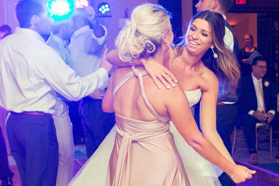 Bride and bridesmaid dancing