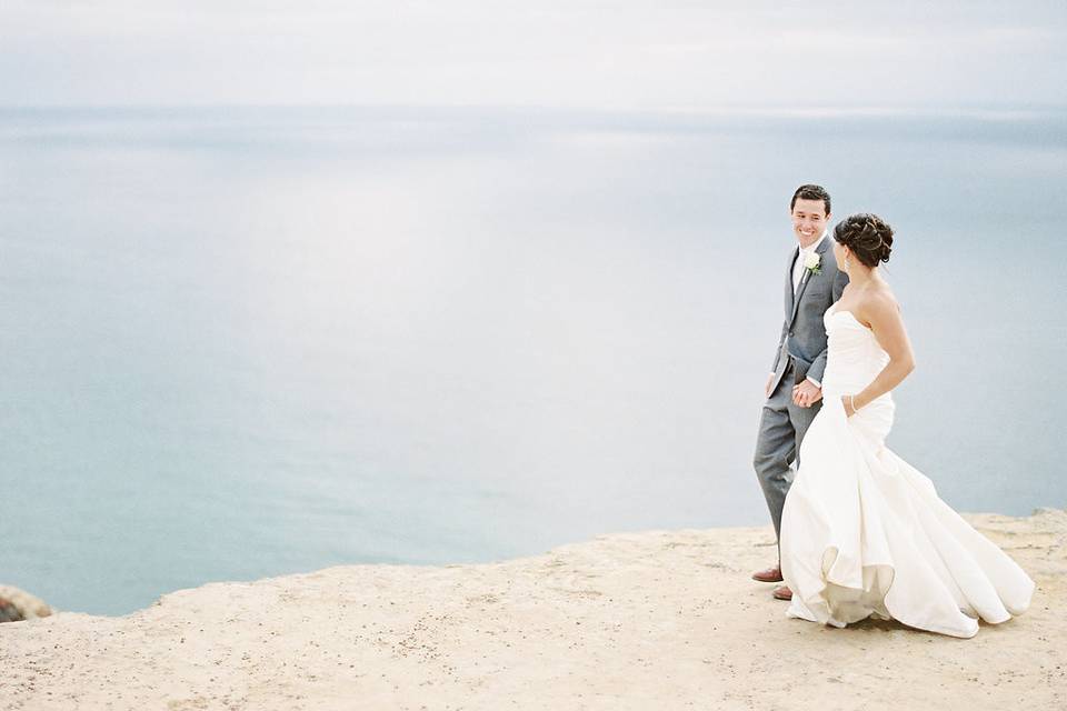Newlyweds overlooking the sea | Photo Credit: whisker & willow photography
