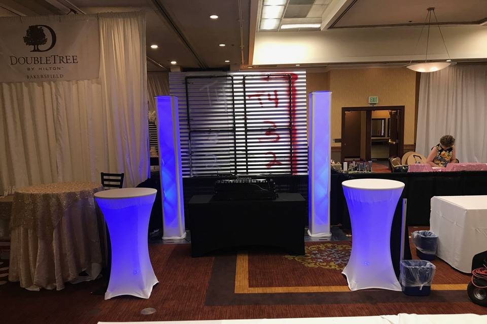 DJ booth and illuminated tables and pillars