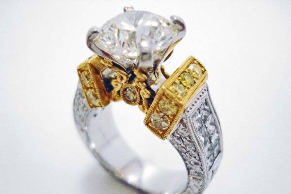 Custom designed 22k/platinum diamond ring containing yellow diamonds.  Ring is hand engraved and is an original design