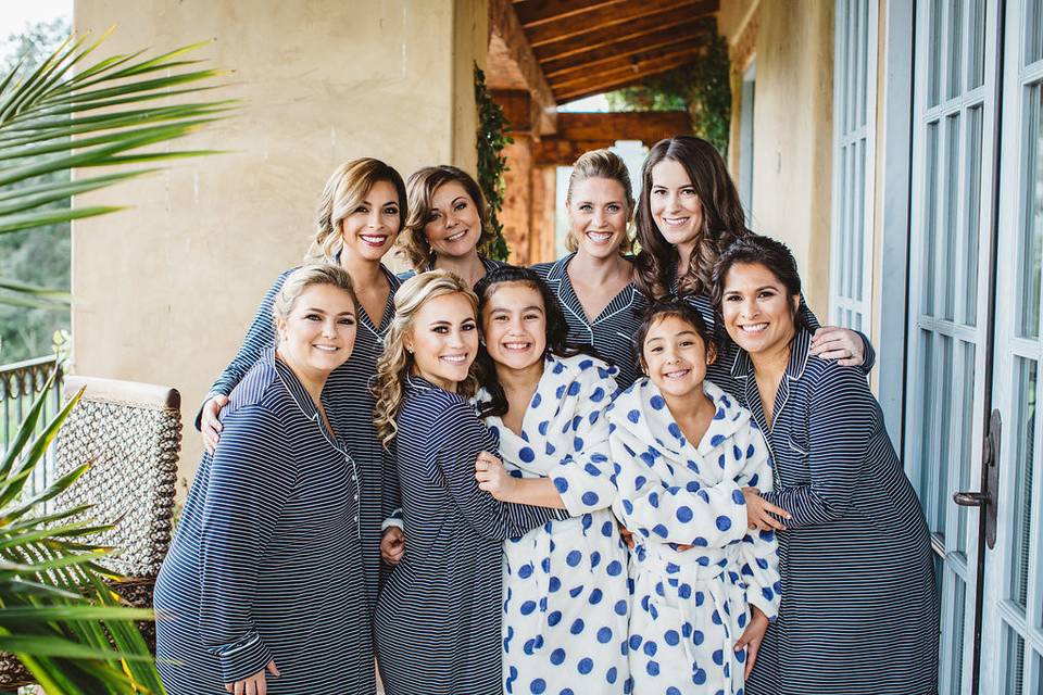 Bride, bridesmaids, and flower girls in their lounge wear