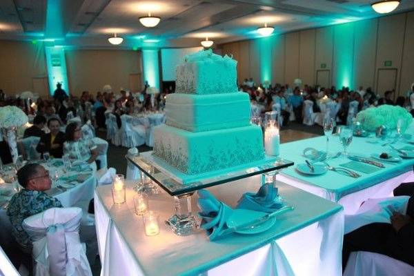 Beautiful glass elevated 3 tier wedding cake with Tiffany Blue Uplighting