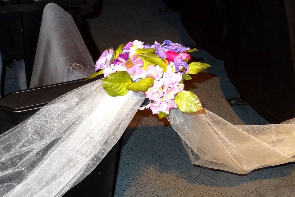 Floral arrangement on church pew.