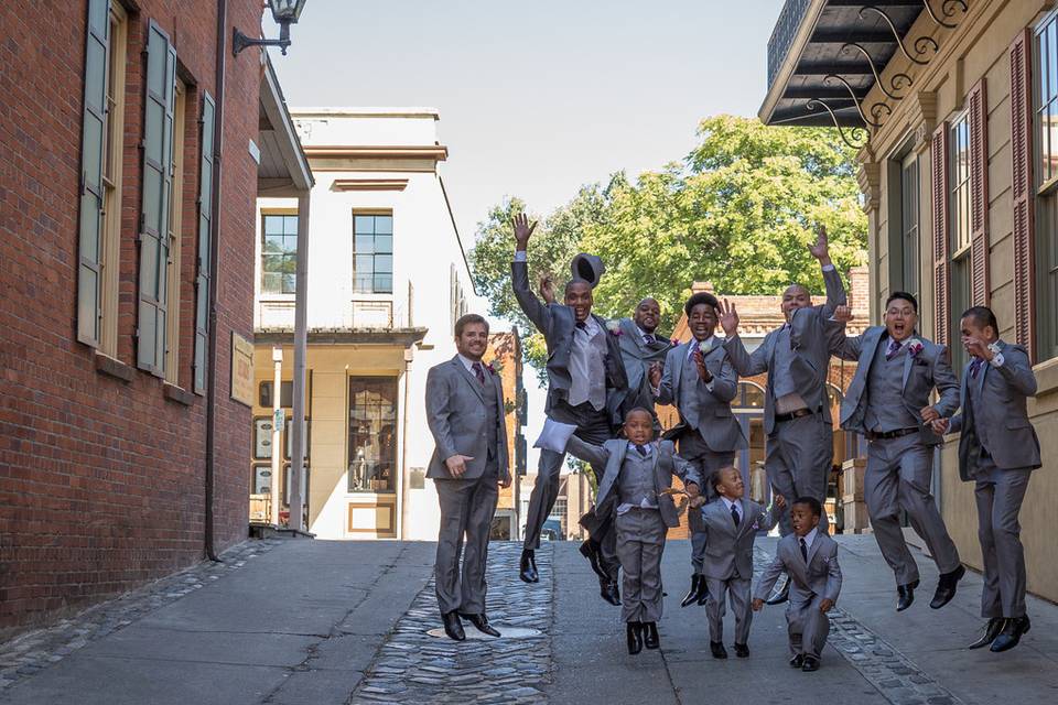 The groom with his groomsmen and the kids at the wedding