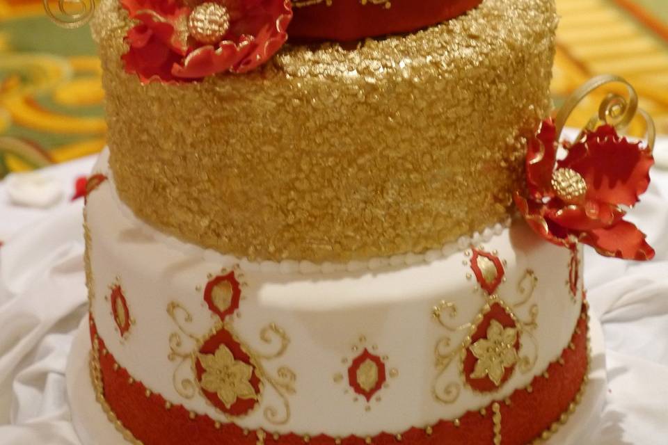 Dramatic red and gold Indian style wedding cake