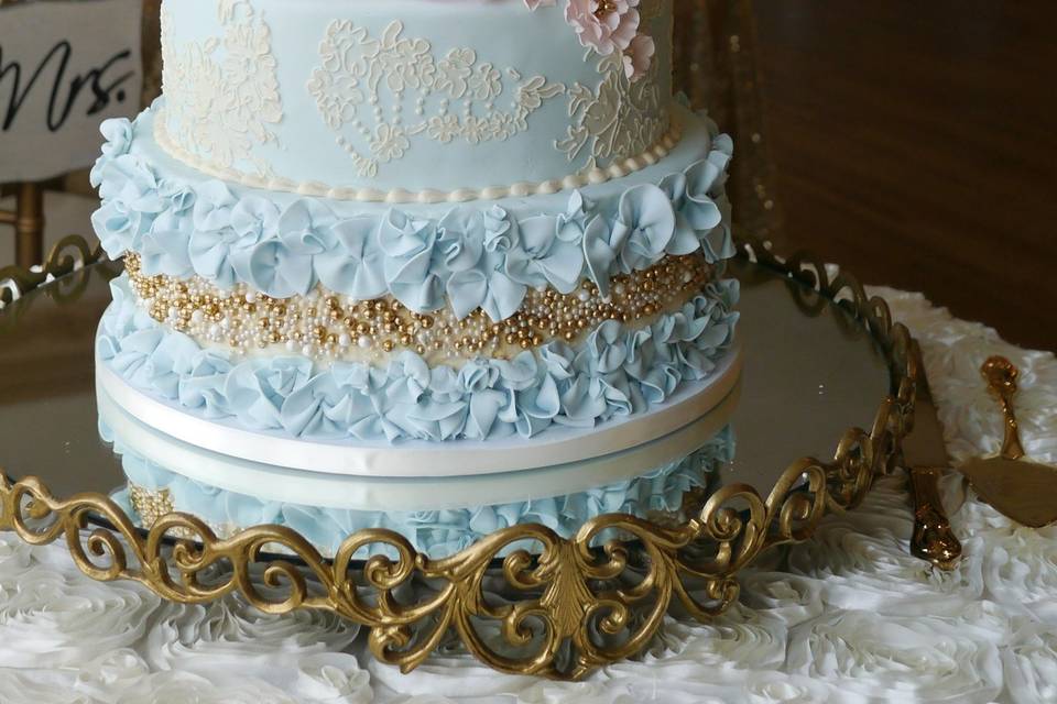 Romantic vintage french inspired cake. Gilded birdcage, sugar flowers and ruffles