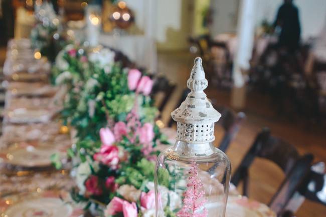 This tablescape featured classic arrangements as well as romantic arrangements inside vintage terrarium bowls with moss and roses