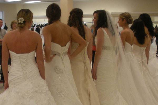 Group of brides trying on dresses