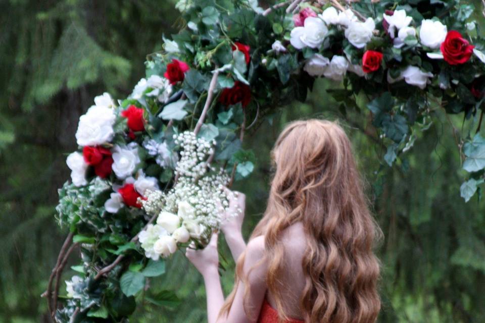 Preparing a gorgeous Wedding Arch filled with luscious white and Red Roses, Baby's breath, Stephanotis and green vines