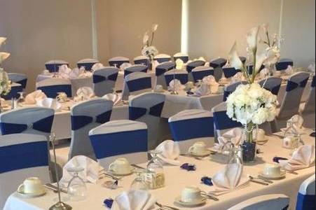 A wedding we've done at the Pearl Country Club in Pearl City, Hawaii. We have done their chair covers using our stretch chair covers and blue stretch chair sash with a rhinestone band.