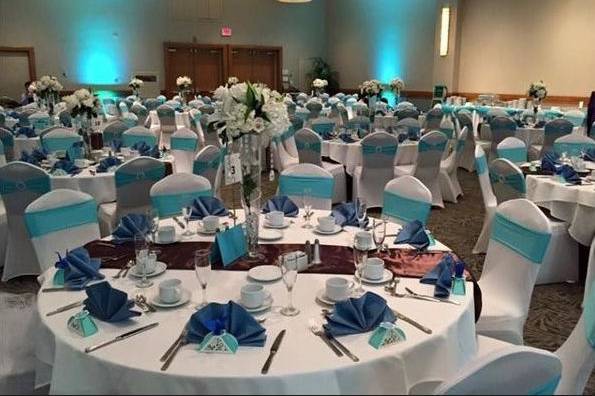 White stretch chair covers, tiffany blue stretch chair sash with round rhinestone band and chocolate table runners for a beautiful wedding at Ala Moana Hotel located in Honolulu, Hawaii