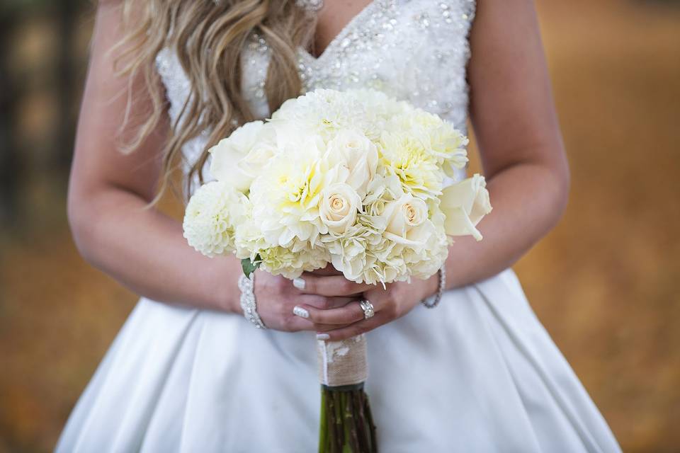 Lush bridal bouquet in creams and whites with roses, hydrangea and dahlias.