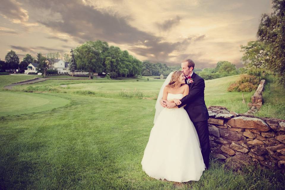 Groom embracing his bride