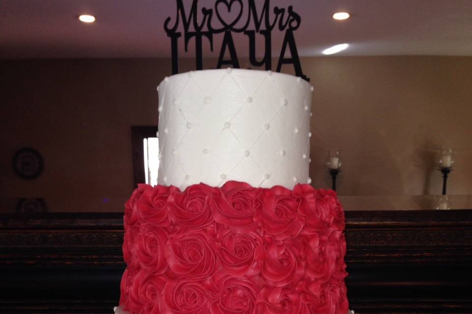 Three tier wedding cake with flowers on top