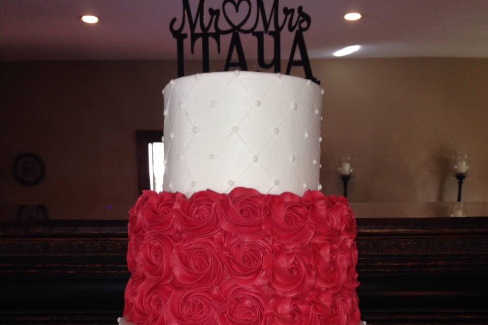 Four tier white and red wedding cake