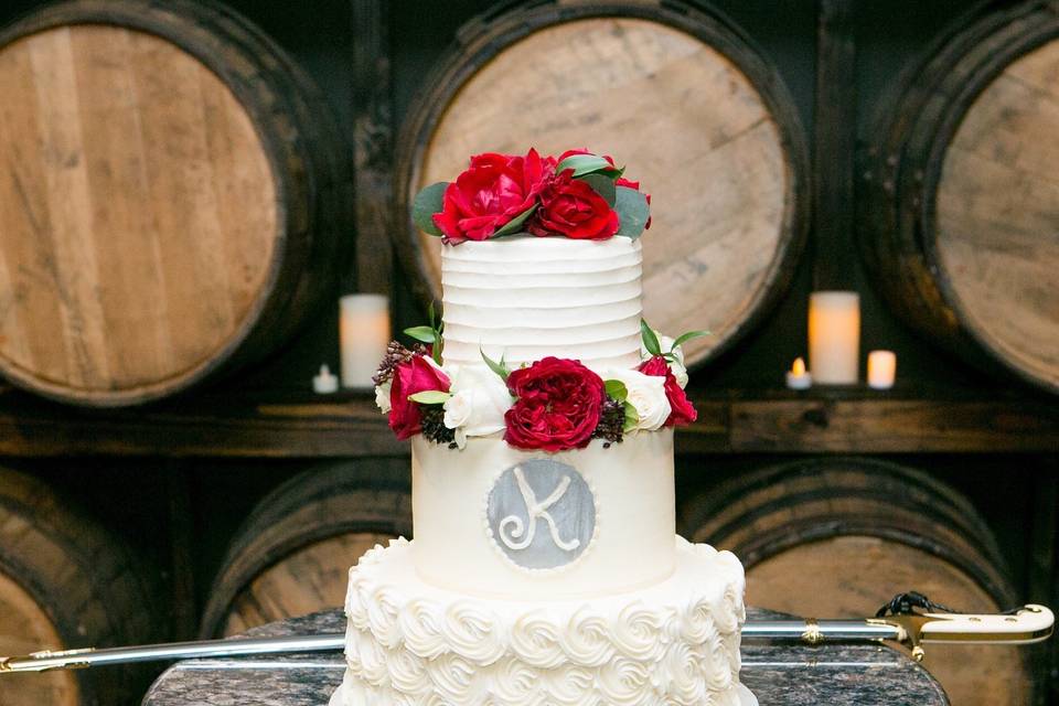 Three tier wedding cake with red roses