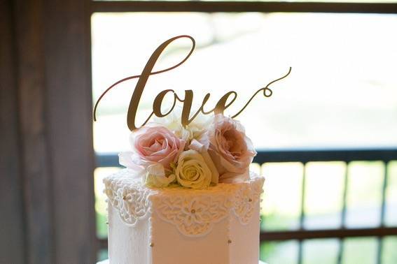 Three tier wedding cake with love on top
