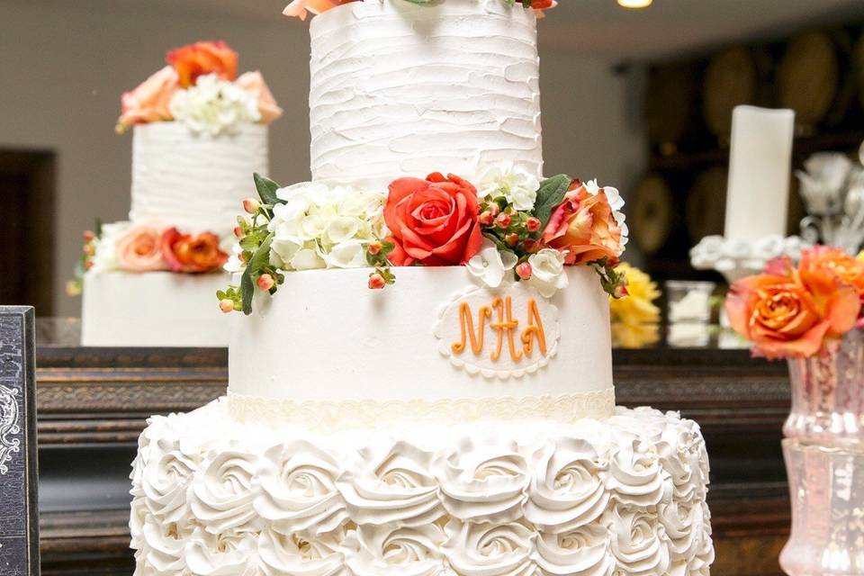 Three tier wedding cake with flowers on top