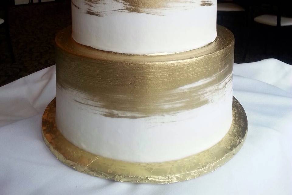 Two tier white and gold cake