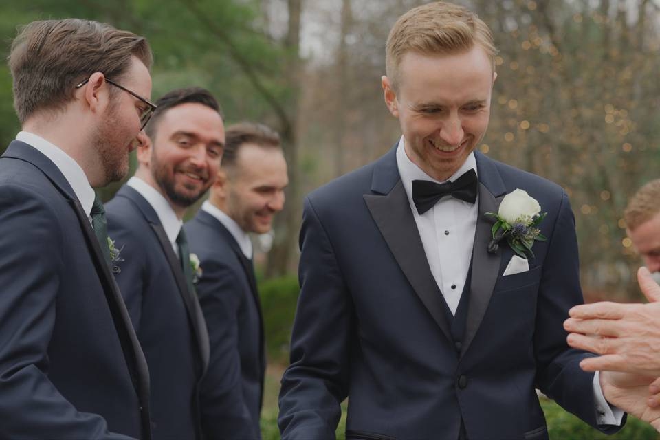 Candid moment with groomsmen.