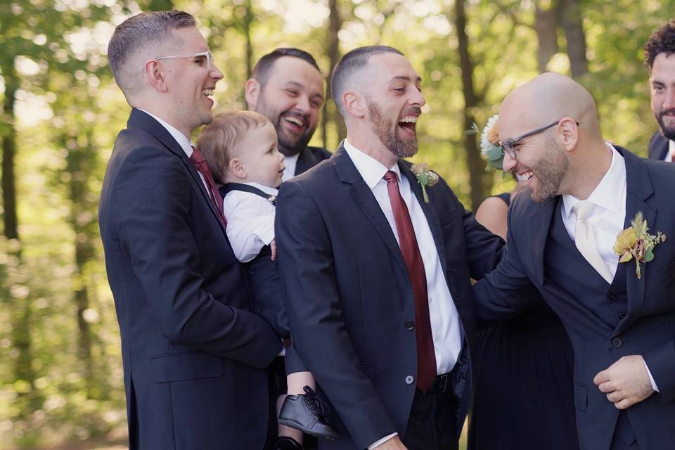 Groom laughing with groomsmen.