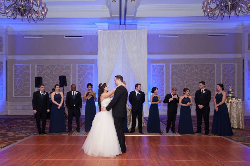 Dancing while wedding party watches