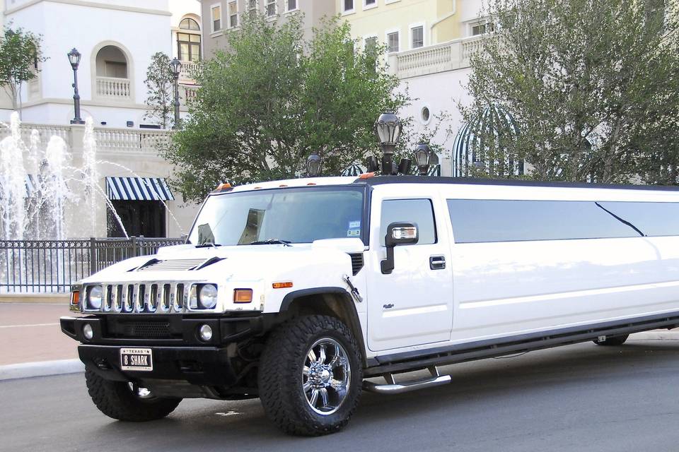**White H2 Super Stretch Hummer Limousines**SHARK LIMOUSINES Our White H2 Super Stretch Hummer Limousines lets you attack the night with up to twenty other man eaters! These shimmering super stars come equipped with multiple LCD TV’s, DVD player, front to back stainless steel mirrors, fiber optic lighting, premium sound system, and an incredible neon bar that is covered with coolers and champagne buckets. There is truly something for everyone in these vehicles, you can even swim to your very own VIP section in the back. Whether it is PROM TIME or PARTY TIME, SHARK LIMOUSINES H2 Hummer Limousines will let you attack the night