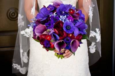 Dark purple orchids, red roses, red peony, purple hydrangea. Photography by Genevieve Leiper.