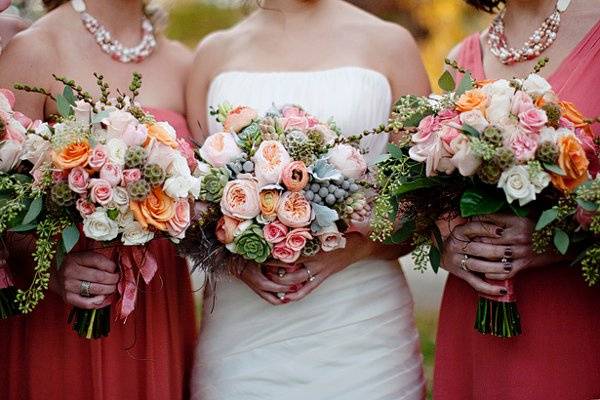 Bouquets that were created with pods, berry, orange roses, spray roses. Photograph by Kristin Gardner.