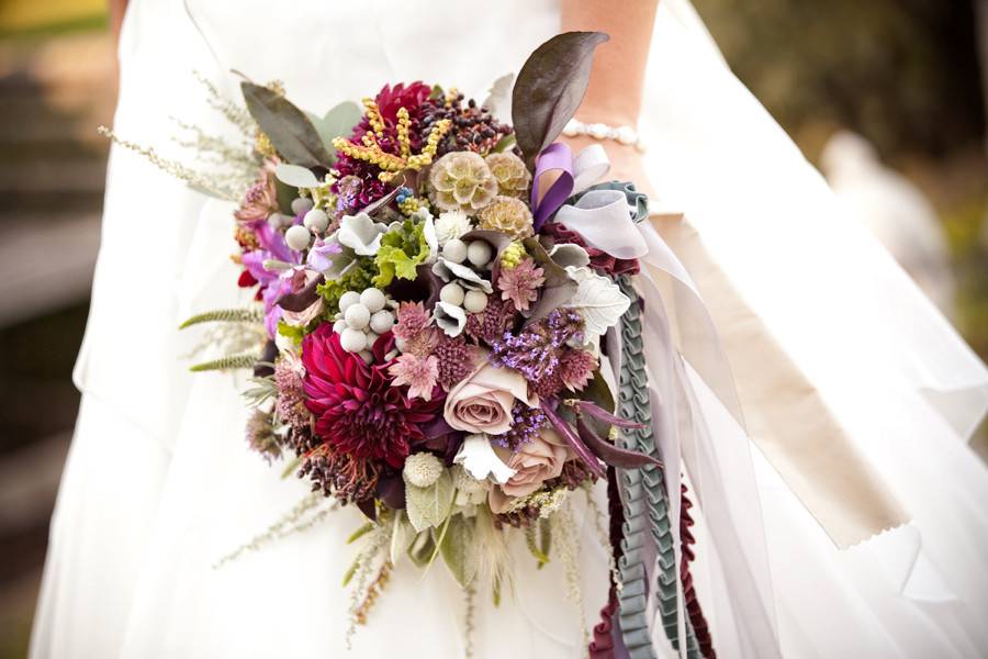 Bouquets that were created with pods, berry, orange roses, spray roses. Photograph by Kristin Gardner.