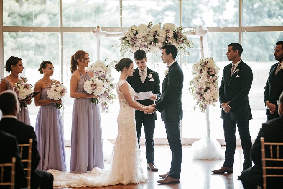 Indoor ceremony in front of windows