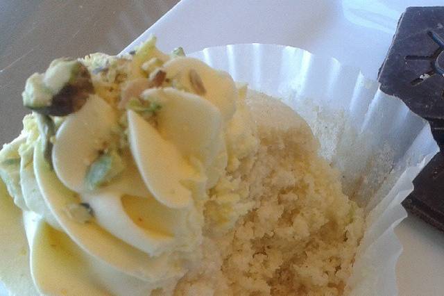 Cardamom Cupcake with Saffron buttercream topped with pistachios.