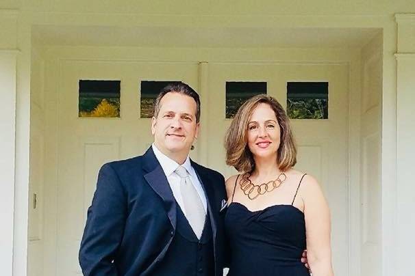 Beautiful Couple ready for a wedding , Black Elegant dress with gold accent jewelry..