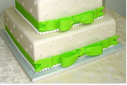 Three layered cake with green ribbons