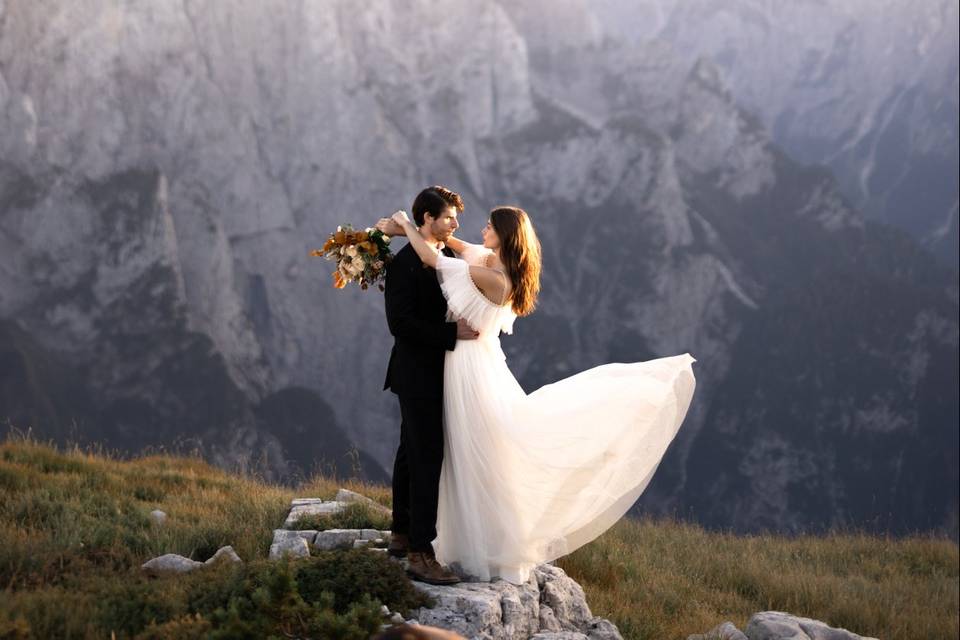Bride and groom on mountainsid