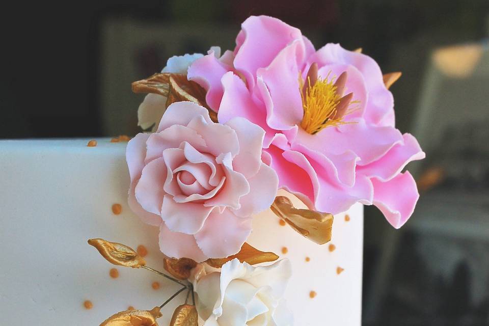 Glamorous pink, gold and white wedding cake with gum paste flowers