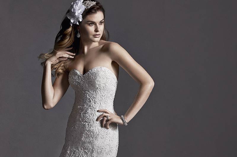 Marlow	<br>	Romantic lace adorns this slim A-line wedding dress, accented with Swarovski crystals and demure sweetheart neckline. Finished with covered button over zipper and inner elastic closure.