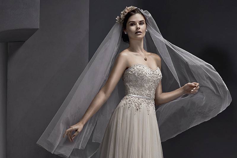 Emsley	<br>	Romance is found in this tulle wedding dress featuring a Swarovski crystal and pearl beaded bodice, accented with sweetheart neckline and thin, optional satin belt. Finished with zipper over inner corset back closure.