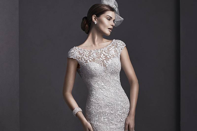 Georgia	<br>	Elaborate lace adorns this sheath wedding gown, with sparkling Swarovski crystals and pearls adorning a bateau neckline. Finished with dainty cap-sleeves and pearl button over zipper closure.