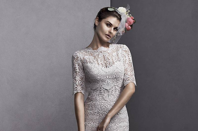 Emmanuelle	<br>	Elaborately patterned Venise lace adorns this slim A-line gown, complete with a scalloped hemline and straps. Available with lace jacket with scalloped sleeves and neckline. Finished with covered button over zipper closure.