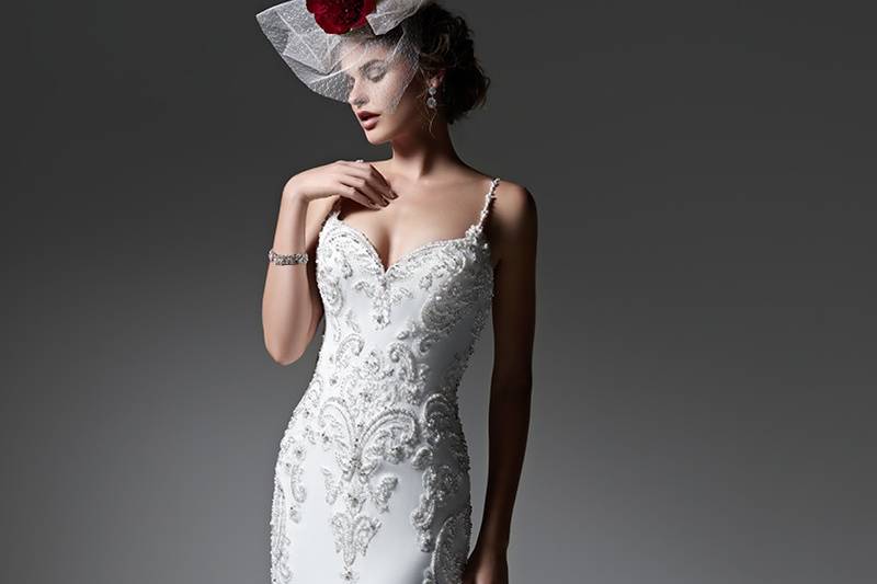 Style Samirah <br> Elegant Paris chiffon creates this streamlined sheath wedding dress, accented with sparkling Swarovski crystals and opalescent pearls. Finished with sexy beaded spaghetti straps, romantic sweetheart neckline and crystal buttons over zipper closure.