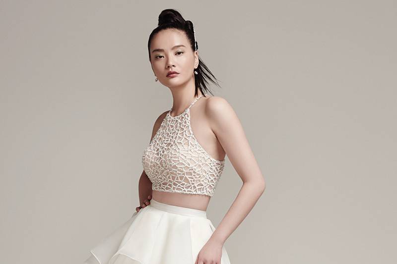 Jude <br> Sophisticated bead encrusted cropped halter with crystal button closure and bandeau lining. Layered Marquice organza ball gown skirt with zipper closure.