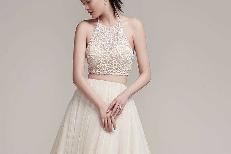 Jude <br> Sophisticated bead encrusted cropped halter with crystal button closure and bandeau lining. Full tulle A-line skirt with zipper closure.