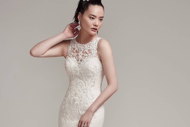 Rae <br> Swarovski crystals adorn this modern lace and tulle fit and flare wedding dress with sexy illusion sweetheart neckline and soft-sweeping train. Finished with intricate illusion lace back and crystal buttons over zipper closure.